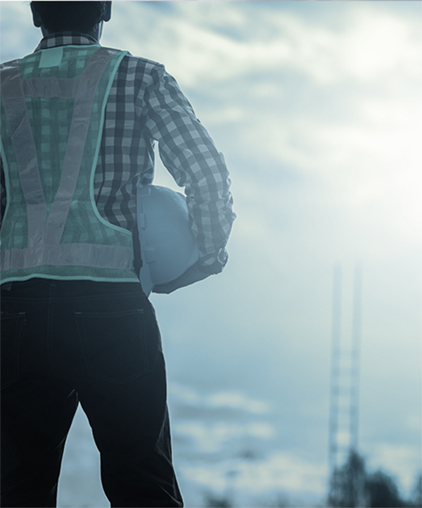 MAn with construction hat staring off into the horizon