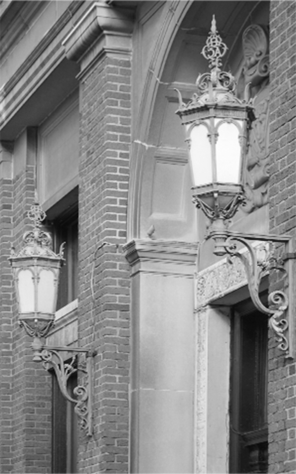 Black and white picture of a latern attached to a building