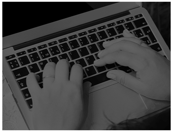 Close up of hands typing on a laptop